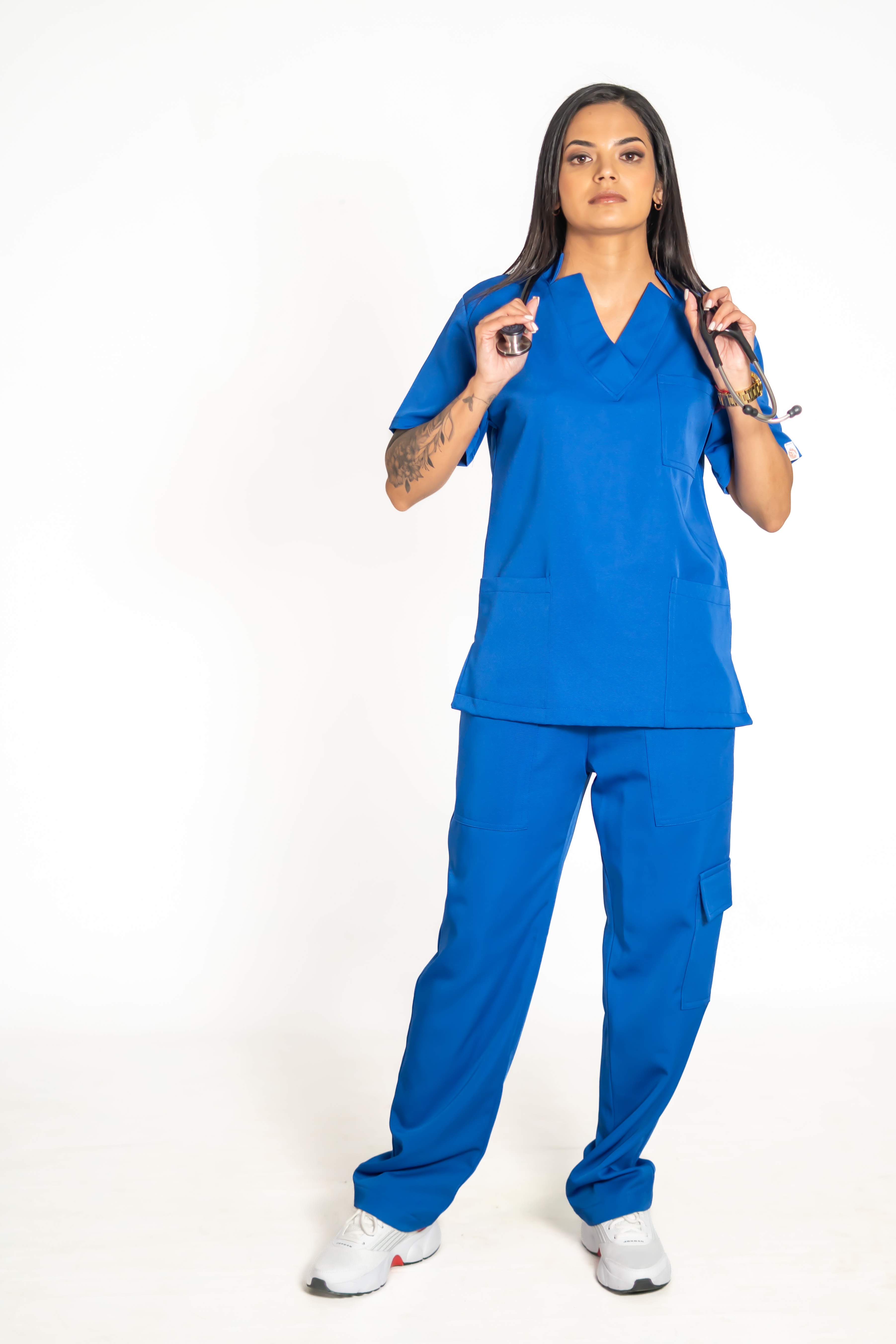 Stretch team scrubs in cobalt blue worn by medical staff with stethoscopes