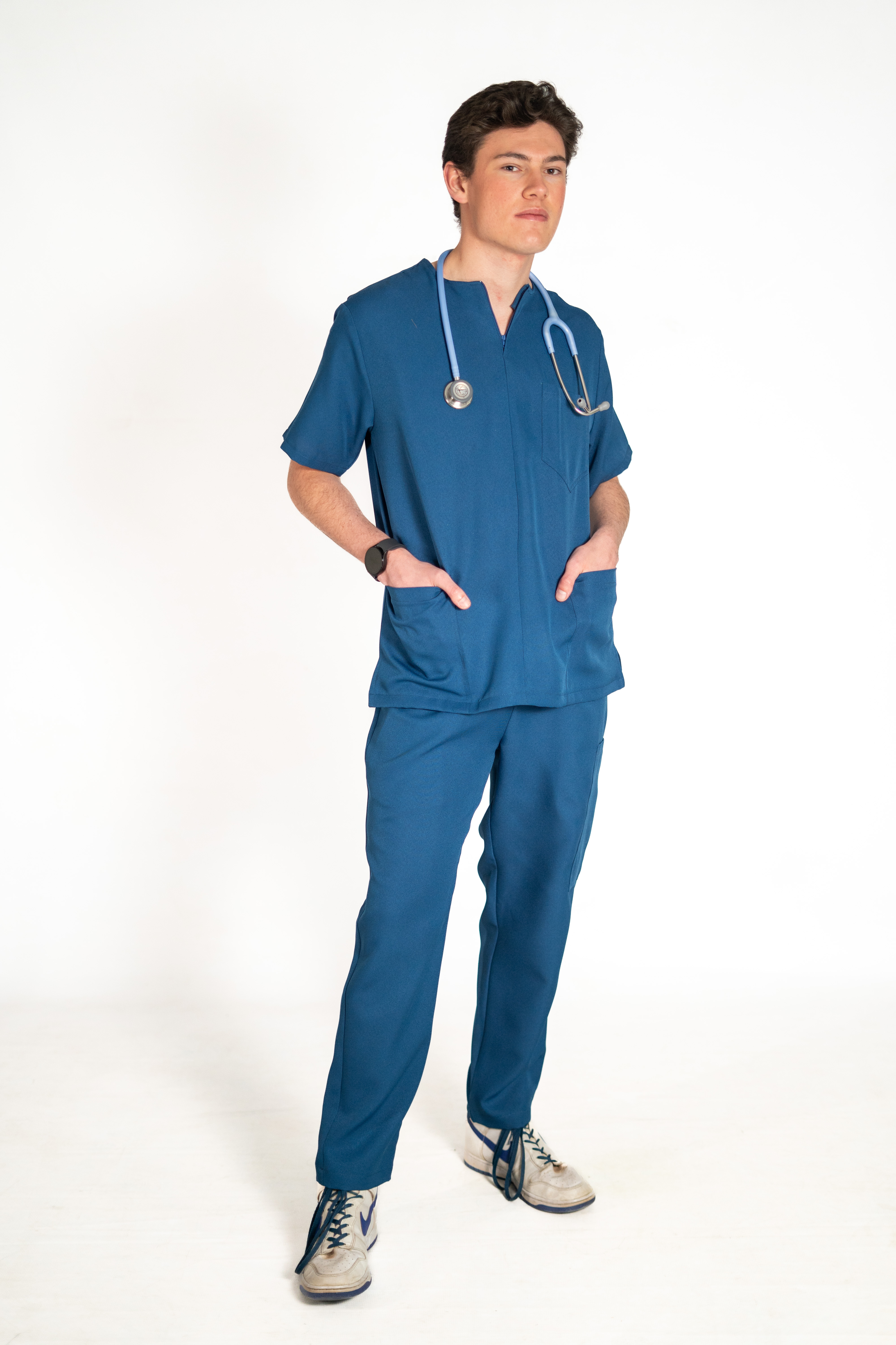 PolyBlend team scrubs in sage green and cacao worn by a healthcare team
